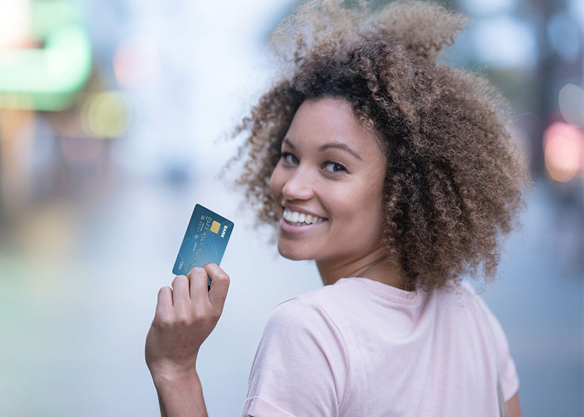 Smiling woman with credit card