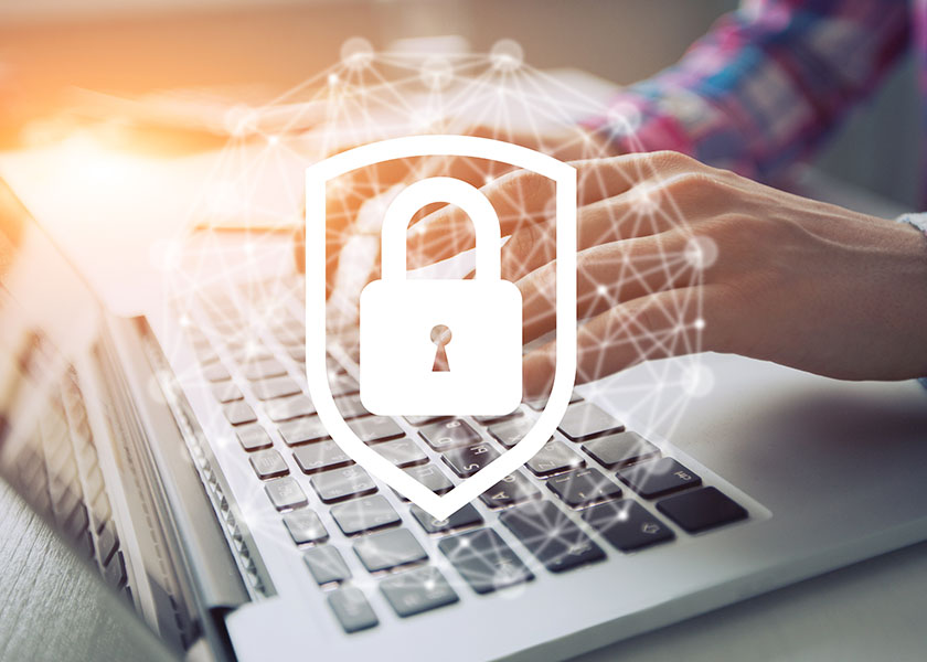 Hands typing on a laptop with a digital lock icon overlay, symbolizing online security and protecting personal information from scams.